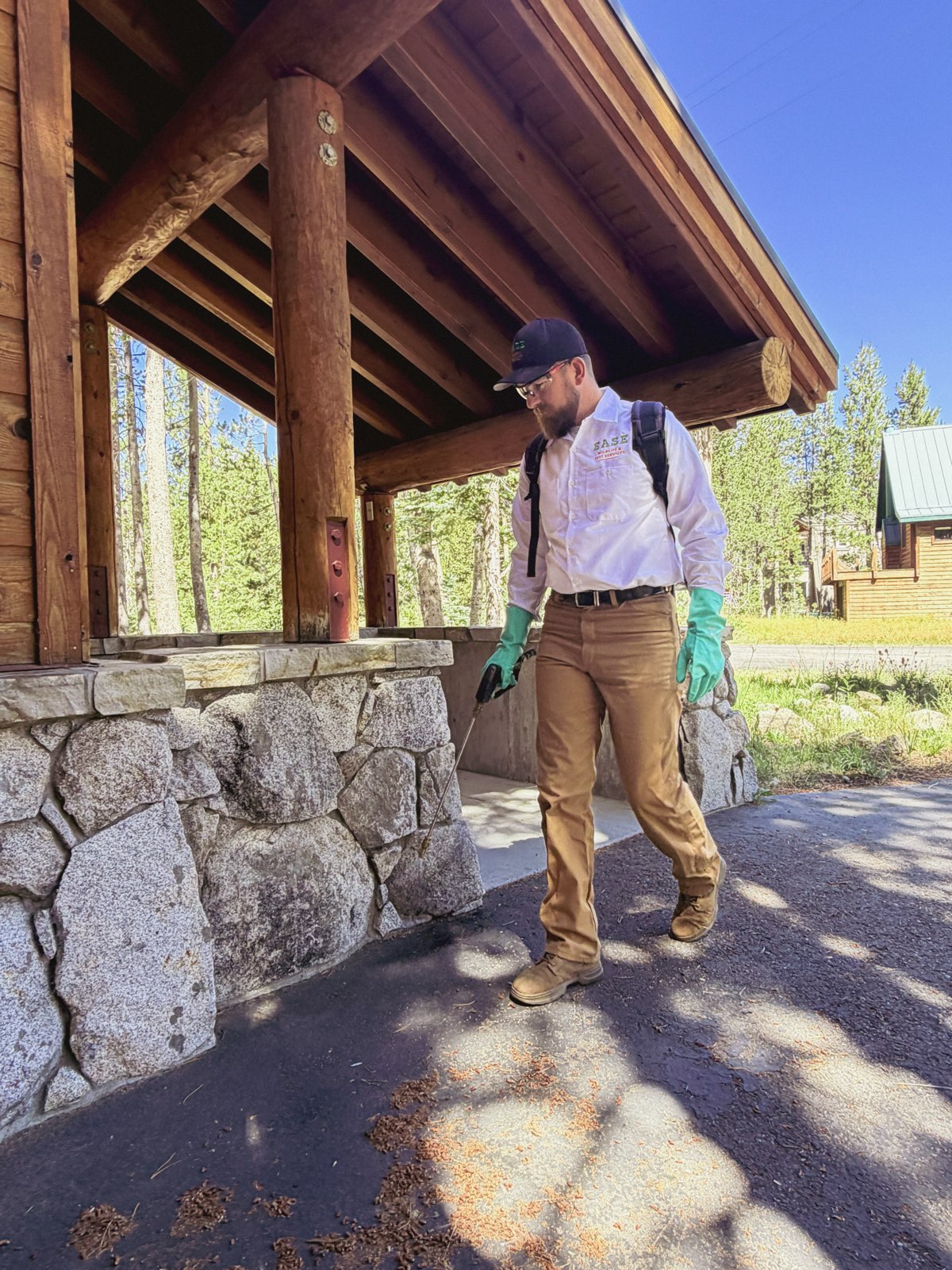 Ease technician treating the exterior of a Sacramento-area home during a service visit